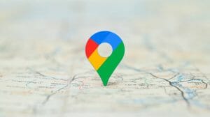 An image of a map pin in Google colors on a map for an article titled mastering google maps.