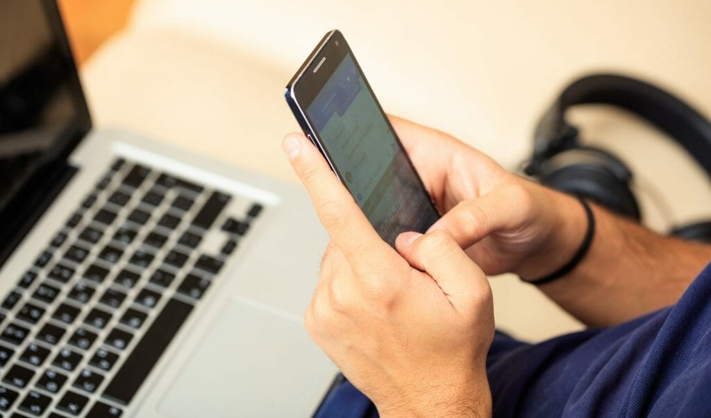 man-looking-at-his-smart-phone in an article about mastering google maps